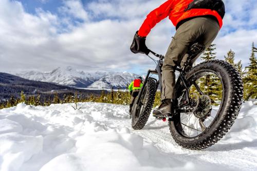 a person riding a bike in the snow at Special! New Downtown Mtn View Free Parking 2b&2b in Canmore