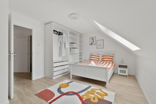 une chambre blanche avec un lit et un placard dans l'établissement Résidence belle air, à Porcheville