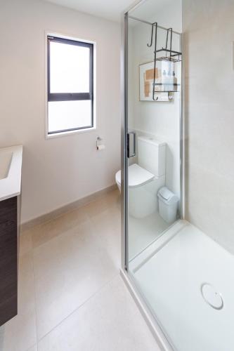 a bathroom with a toilet and a glass shower at Family Friendly Near Waltham Pool in Christchurch