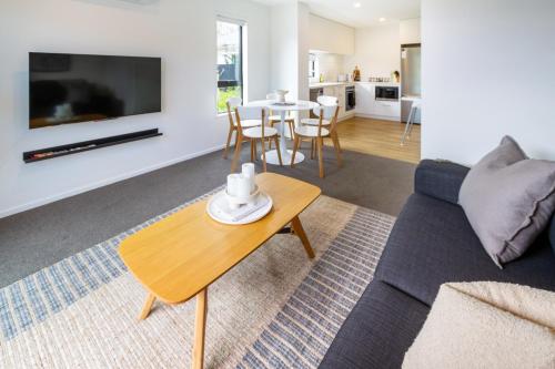 a living room with a couch and a table at Family Friendly Near Waltham Pool in Christchurch