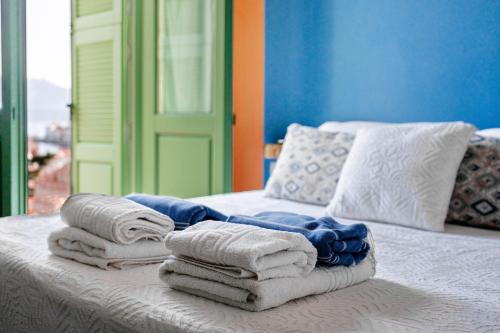 a pile of towels sitting on top of a bed at Blue Horizon Kastellorizo in Meyisti