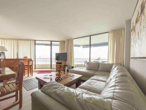 a living room with a couch and a table at Departamento Grande en San Alfonso del Mar 4D 3B 2EST in Algarrobo