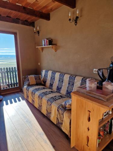 a living room with a couch and a large window at Holiday House Clavis in Dobrovnik