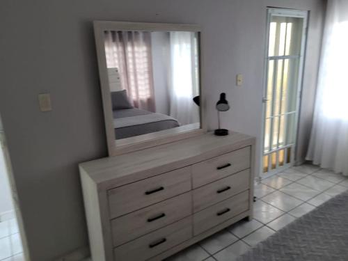 a dresser with a mirror on top of it at Pal Campo in Hucares