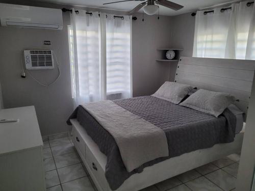 a bedroom with a bed and a window with a fan at Pal Campo in Hucares
