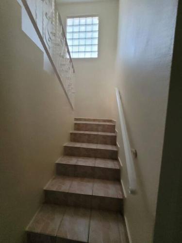a stairway with a window and a stair case at Pal Campo in Hucares