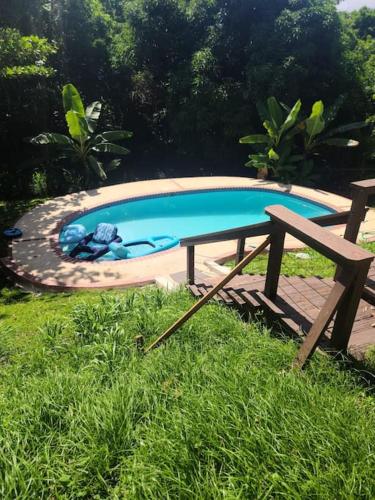 a picnic table and a swimming pool in the grass at Pal Campo in Hucares
