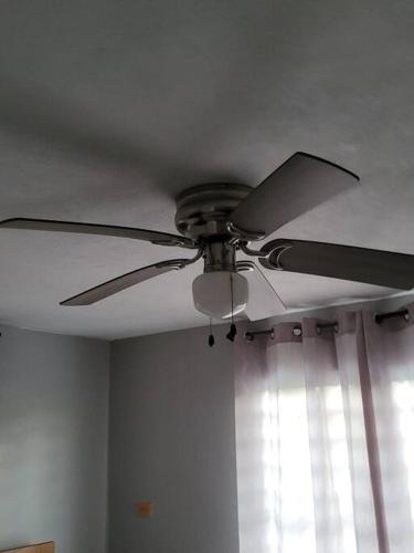 a ceiling fan in a room with a window at Pal Campo in Hucares