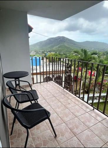 a balcony with two chairs and a table and a view at Pal Campo in Hucares