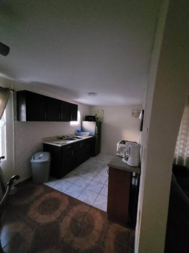 a small kitchen with a sink and a refrigerator at Pal Campo in Hucares
