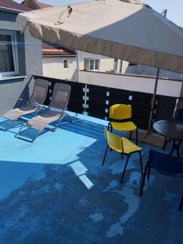 three chairs and an umbrella on top of a pool at Hauptmann5 in Waldmünchen