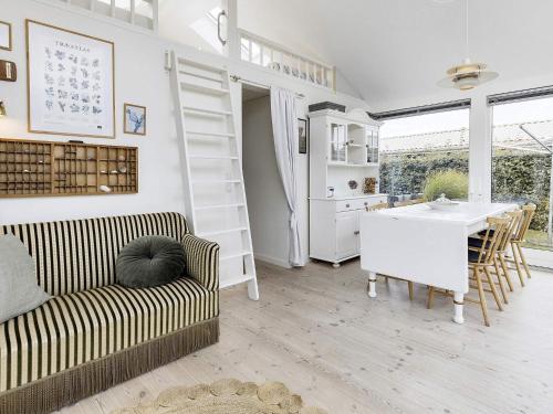 a living room with a couch and a table at 4 person holiday home in Karrebæksminde in Karrebæksminde