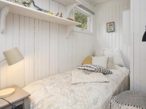 a bedroom with a bed in a white room at 5 person holiday home in Thyholm-By Traum in Thyholm