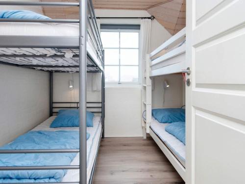 two bunk beds in a room with a window at Luxury Beach Retreat - By Traum Ferienwohnungen in Harboør