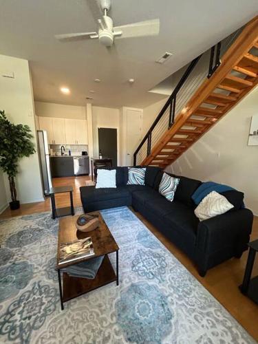 a living room with a couch and a table at 1 Bedroom Studio Townhouse in Uptown Charlotte in Charlotte