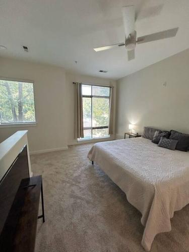 a bedroom with a bed and a ceiling fan at 1 Bedroom Studio Townhouse in Uptown Charlotte in Charlotte