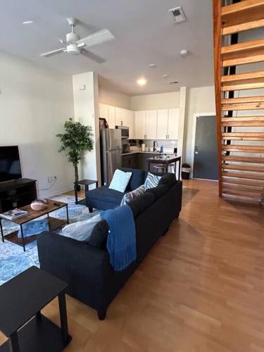 a living room with a couch and a kitchen at 1 Bedroom Studio Townhouse in Uptown Charlotte in Charlotte