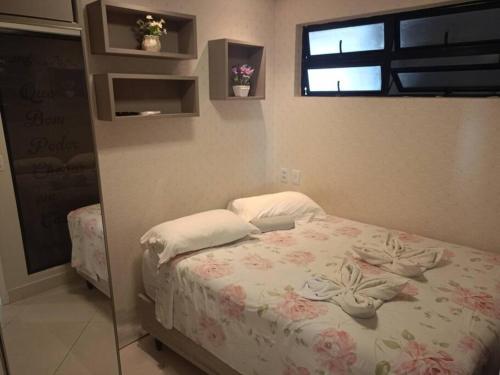 a bedroom with a bed with a laptop on it at landscap Meireles Fortaleza in Fortaleza