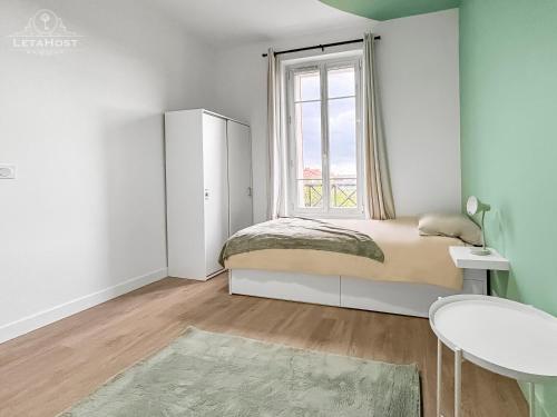 En eller flere senge i et værelse på L'Émeraude Urbaine