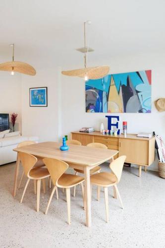 a dining room with a wooden table and chairs at Ripple at Port Willunga in Port Willunga