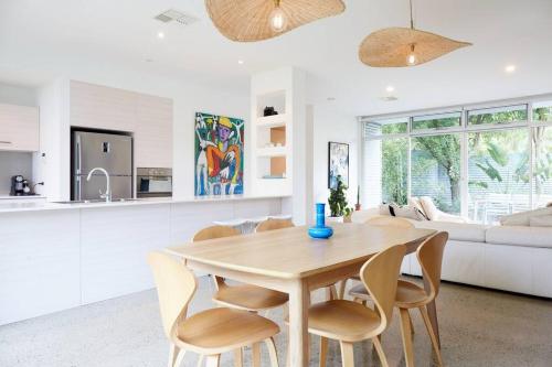 a kitchen and living room with a wooden table and chairs at Ripple at Port Willunga in Port Willunga