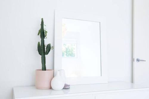 a plant and two vases sitting on a window sill at Ripple at Port Willunga in Port Willunga