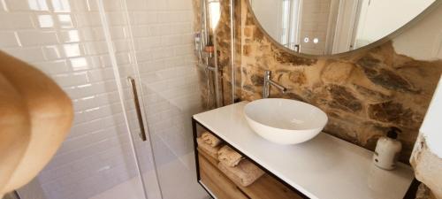 a bathroom with a sink and a mirror at Casita con jardin en Sada in San Andrés de Carnoedo