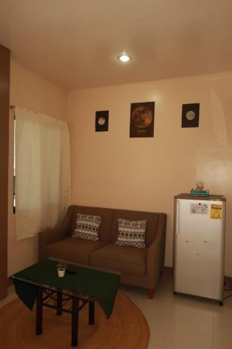 a living room with a couch and a table at Jo-Cris Apartelle in Mactan