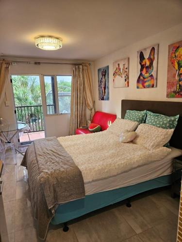 a bedroom with a large bed and a window at Book Now Affordable Cute Cozy studio with Carpark 23 in Auckland