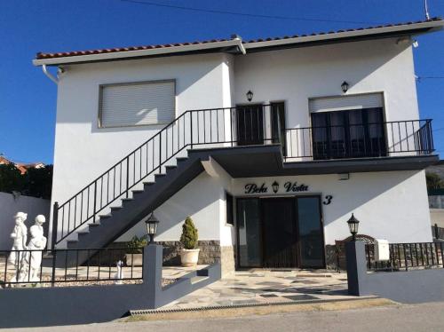 a white building with a staircase in front of it at Affordable Ocean Views! Zambujeira, Lourinha in Serra do Calvo