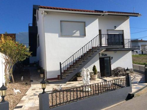 a white house with a staircase in front of it at Affordable Ocean Views! Zambujeira, Lourinha in Serra do Calvo