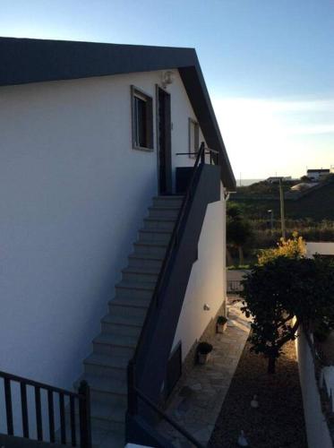 a stairway leading up to a white building with a door at Affordable Ocean Views! Zambujeira, Lourinha in Serra do Calvo