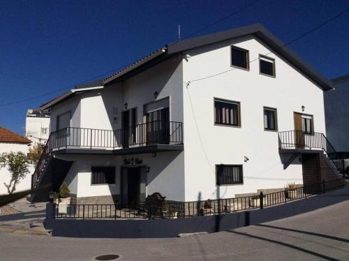 a white building with balconies on the side of it at Affordable Ocean Views! Zambujeira, Lourinha in Serra do Calvo