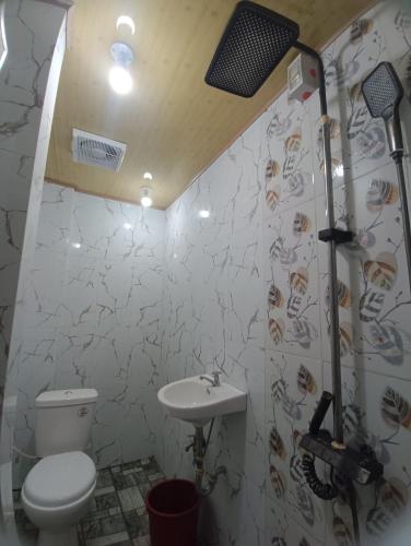 a bathroom with a toilet and a sink at CM Heights Homey 2 bedrooms in General Santos