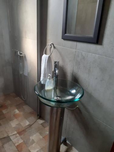 a bathroom with a glass sink and a shower at El Algarrobo in Algarrobo