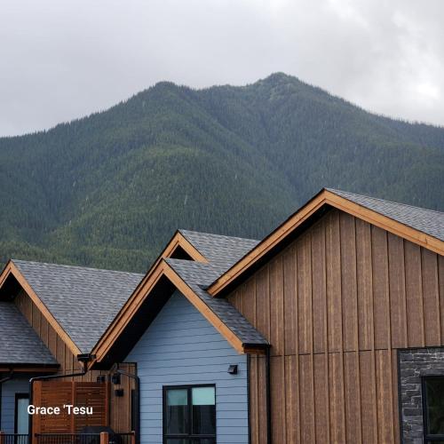 a house with a mountain in the background at Cozy Cove Retreat Escape to Tranquility Stay in Simplicity in Dead Man's Flats