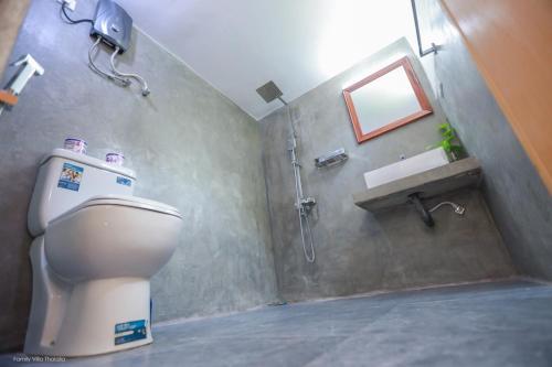 a bathroom with a toilet and a shower and a sink at Family Villa Talalla in Talalla