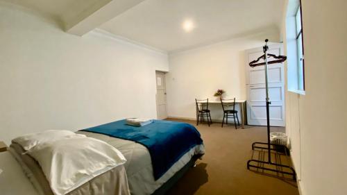 a bedroom with a bed and a table with chairs at Templo de la Luna in Cusco
