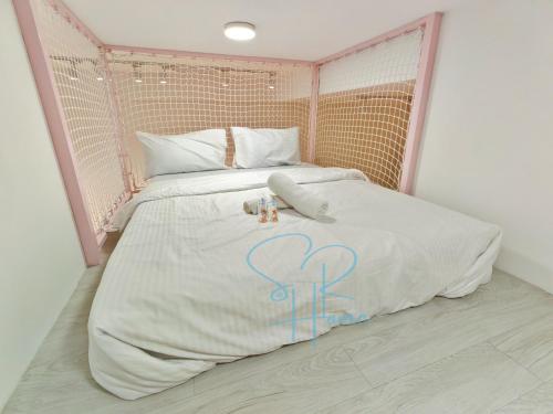 a pink and white bed with two stuffed animals on it at Sunway GRID by SR Home in Kampong Pendas