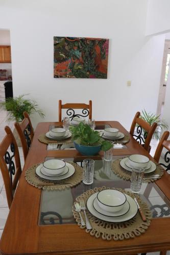 a wooden table with plates and bowls on it at Harmony in Palenque
