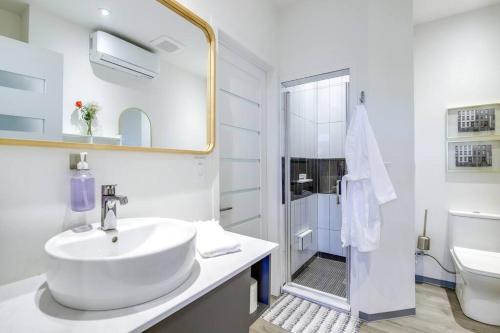 a white bathroom with a sink and a shower at Luxury Barndo 2AN Europe Style Farm Stay Chickens in Jefferson City