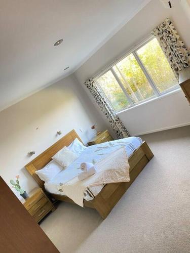 a bedroom with a bed and a large window at Russell's Secluded Secret in Russell