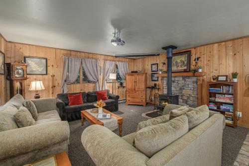 a living room with two couches and a fireplace at Bear Paw by NW Comfy Cabins in Leavenworth