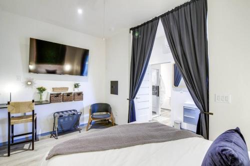 a bedroom with a bed and a desk and a tv at Luxury Barndo 2AS EuropeStyle Farm Stay Fresh Eggs in Jefferson City