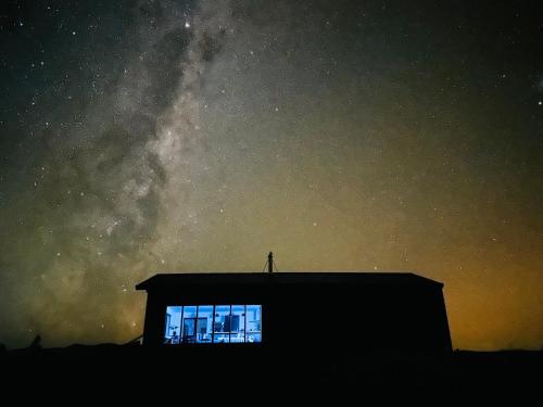 a building with a window under a starry sky at Manuka Vista in Twizel