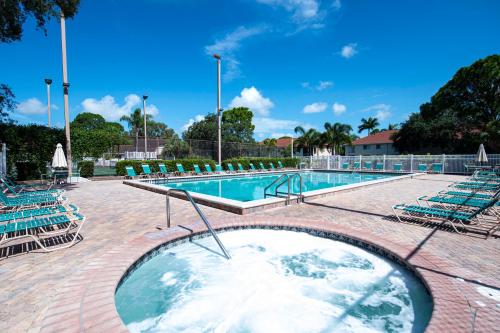 a swimming pool with chairs and a swimming pool at Florida Bella Rosa near IMG Academy & beaches in Bradenton