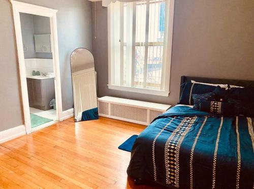 a bedroom with a bed and a large window at Historic Downtown 3bdr with Pool Table in Louisville