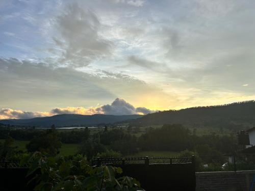 a view of the mountains with a cloudy sky at Cabaña en Tapalpa Morada de Cervantes Suite Dulcinea in Tapalpa