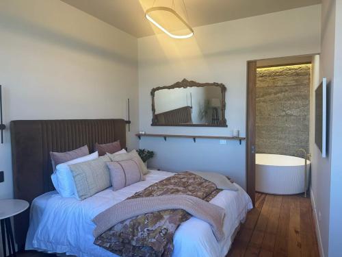a bedroom with a large bed and a mirror at The Verdict in Martinborough 