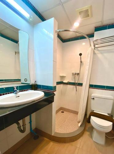 a bathroom with a sink and a toilet and a shower at New Siam II in Bangkok